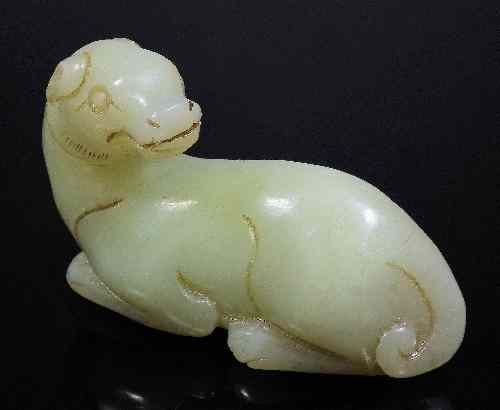 Appraisal: A Chinese celadon jade carving of a recumbent dog in