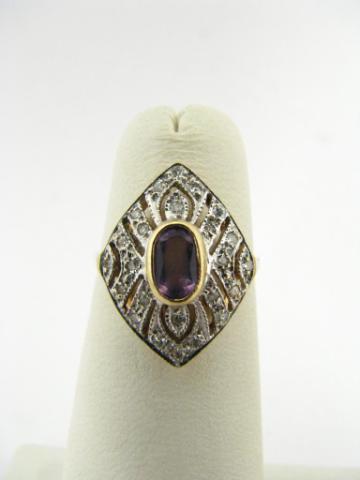 Appraisal: K yellow gold ring with purple oval center stone scuffed