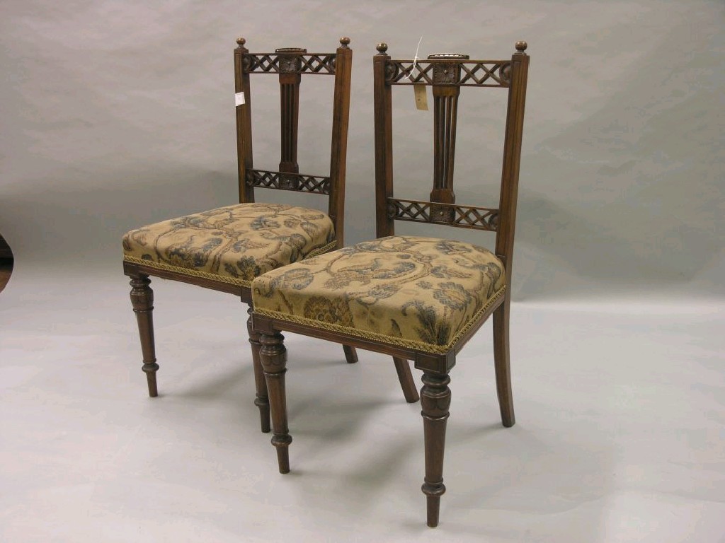 Appraisal: A set of four Edwardian walnut dining chairs pierced backs