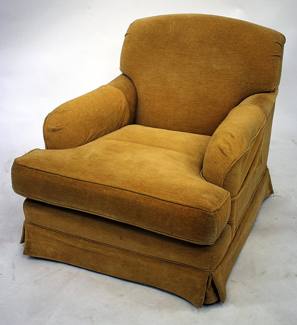 Appraisal: A MODERN HOWARD STYLE YELLOW UPHOLSTERED ARMCHAIR standing on turned