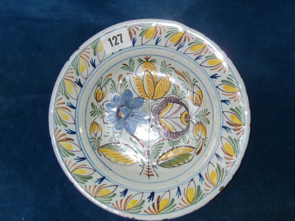 Appraisal: An th century tin glazed earthenware dish with painted floral