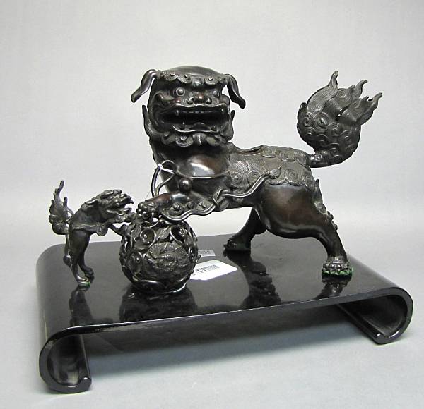 Appraisal: A patinated bronze lion censer Cast in two sections with