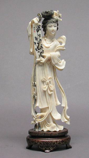 Appraisal: A tinted ivory beauty holding a landscape scroll th Century