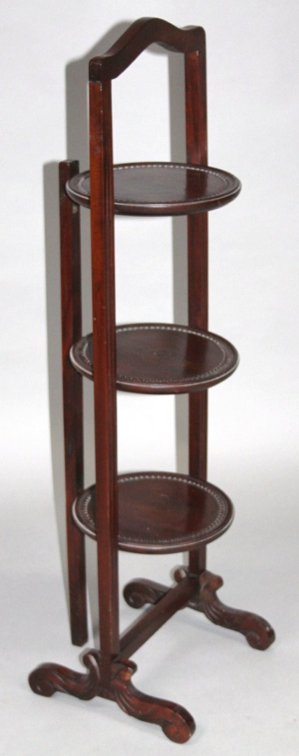 Appraisal: A mid- thC mahogany three sectional cake stand with shaped