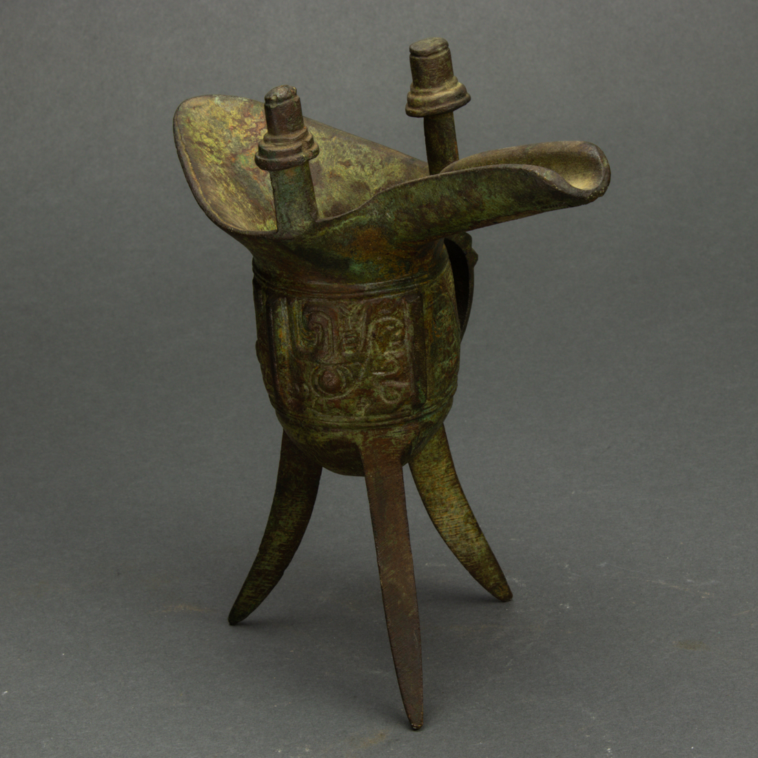 Appraisal: CHINESE BRONZE TRIPOD WINE VESSEL Chinese bronze tripod wine vessel