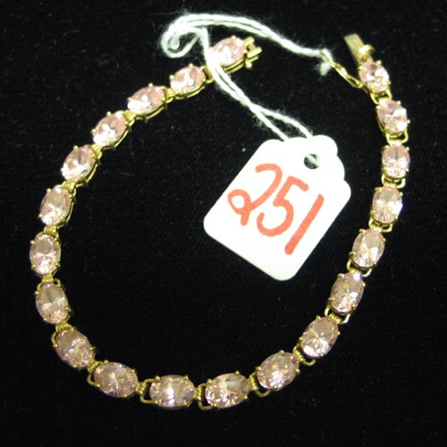 Appraisal: PINK ZIRCON AND TEN KARAT GOLD BRACELET set with oval-cut