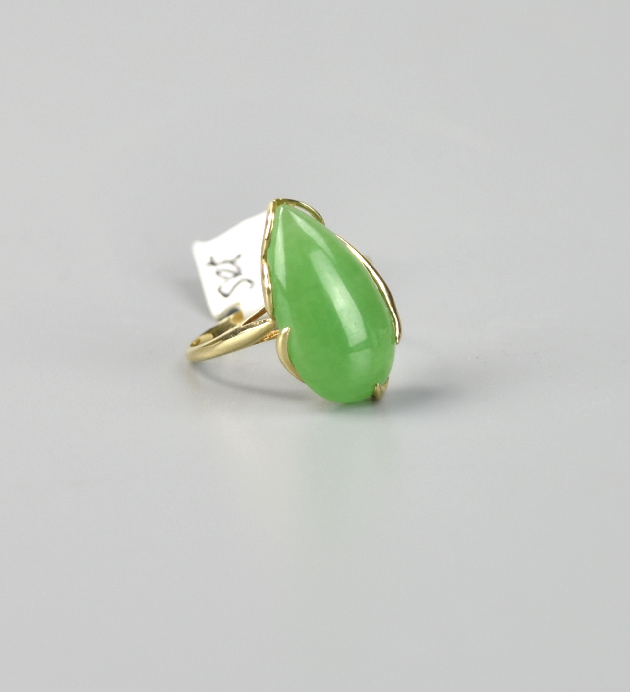 Appraisal: CHINESE GREEN JADEITE RING W K SET a tear drop