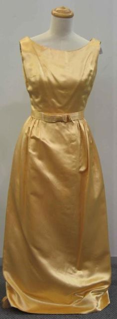 Appraisal: Evening dress in gold silk satin with bowed belt circa