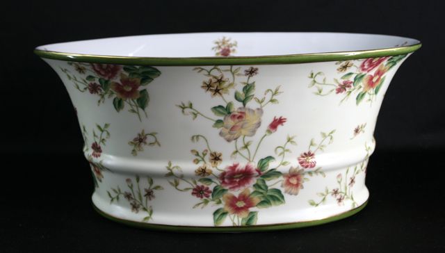 Appraisal: A German porcelain jardiniere with painted floral sprays cm long