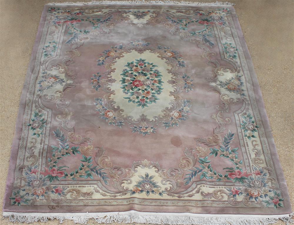 Appraisal: TWO CHINESE CARVED WOOL RUGS the first with oval floral