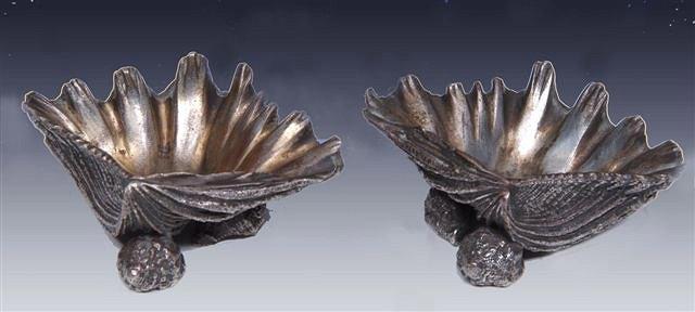 Appraisal: A PAIR OF ITALIAN CAST AND SILVERED BRONZE SALTS in