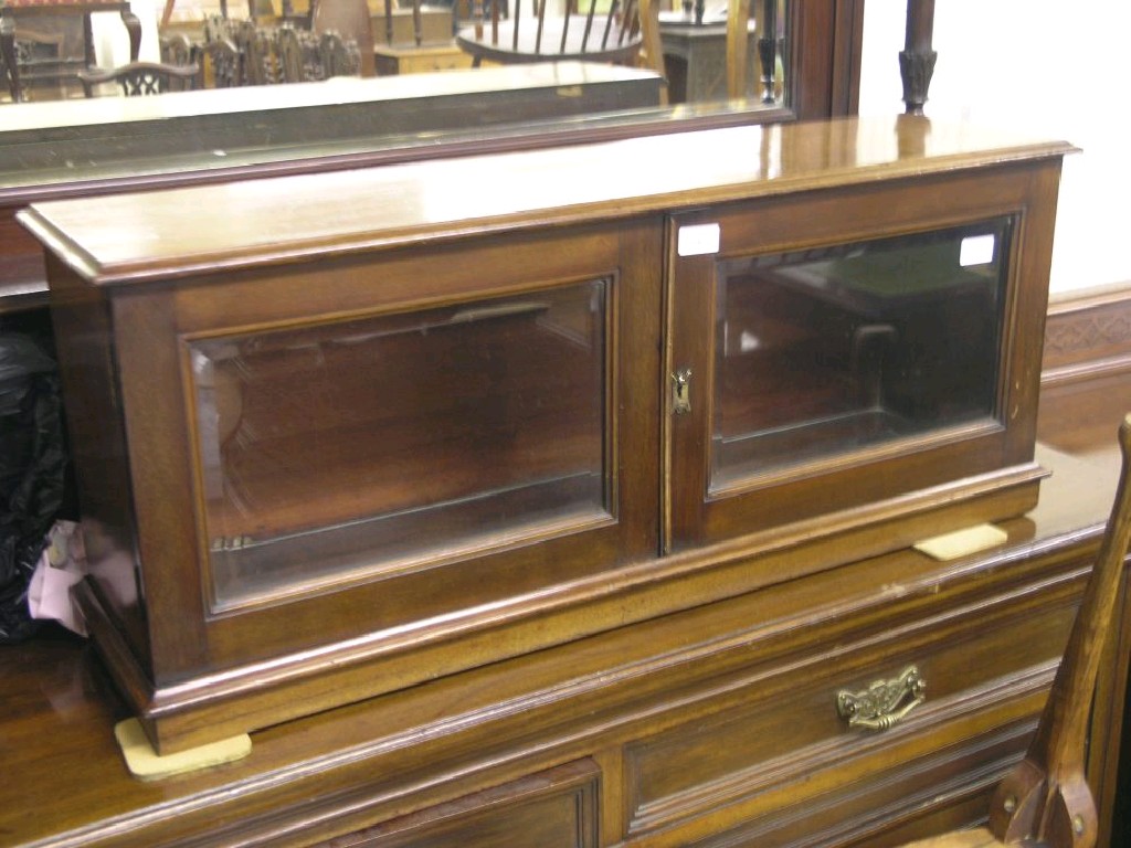 Appraisal: A late Victorian mahogany show-case enclosed by a pair of