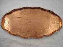 Appraisal: An oval Arts and Crafts style copper tray with beaten