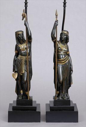 Appraisal: PAIR OF EGYPTIAN REVIVAL BRONZE AND PARCEL-GILT FIGURES MOUNTED ON