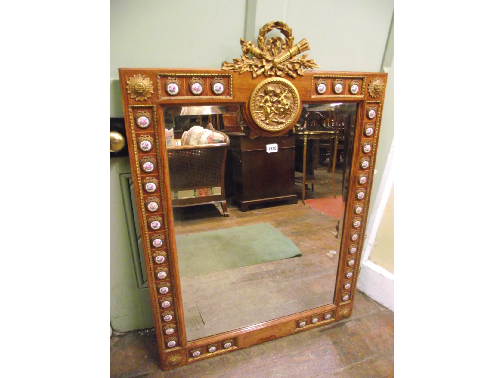 Appraisal: A continental wall mirror with rectangular bevelled edged mirror plate