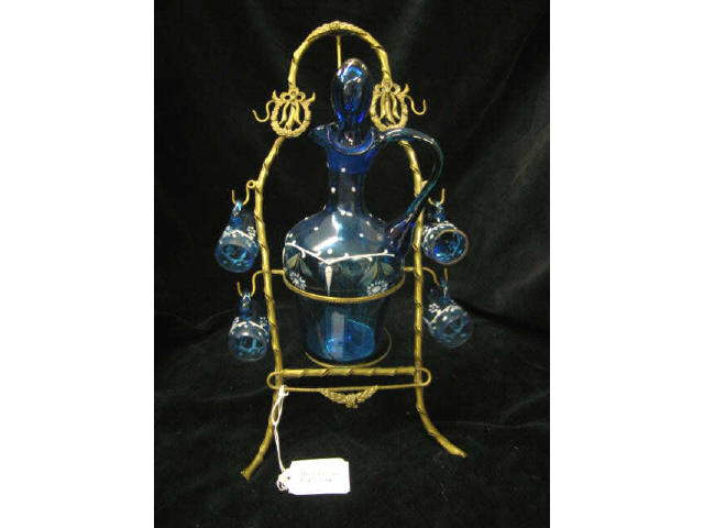 Appraisal: Victorian Art Glass Decanter Cordials on ornate brass stand enameled