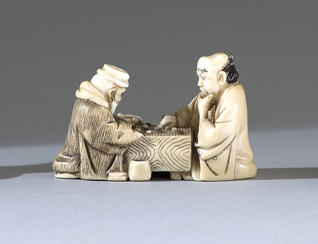 Appraisal: IVORY NETSUKE Early th CenturyDepicting two sages playing Go Signed