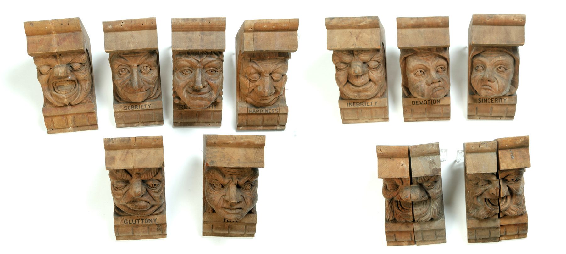 Appraisal: GROUP OF FIGURAL CORBELS American ca pine Well carved faces