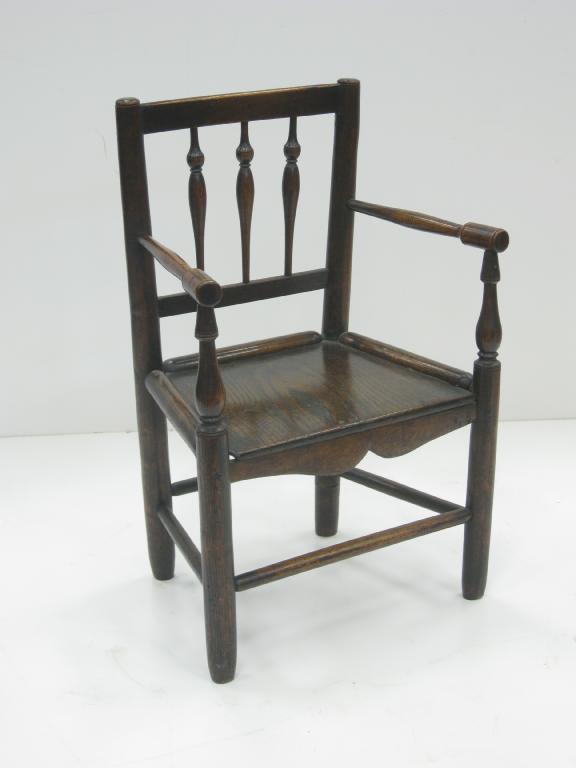 Appraisal: A th Century child's spindle back Elbow Chair with solid