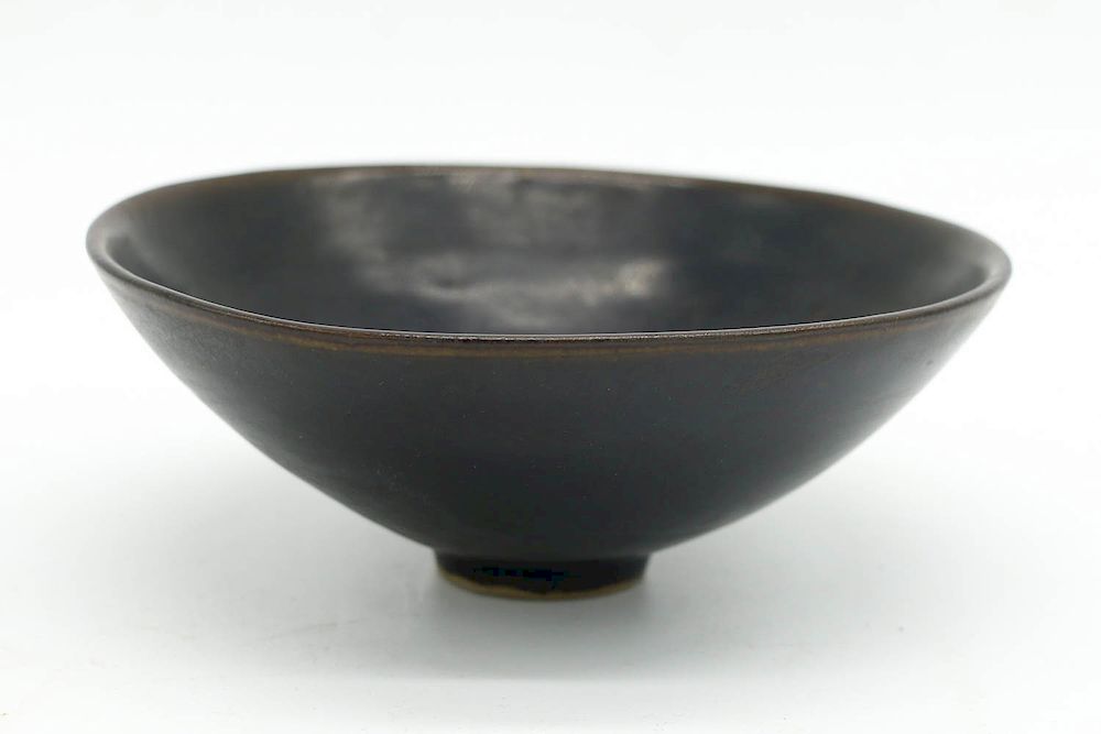 Appraisal: DING-STYLE HENAN BLACK GLAZED BOWL QING DYNASTY Of tapering body