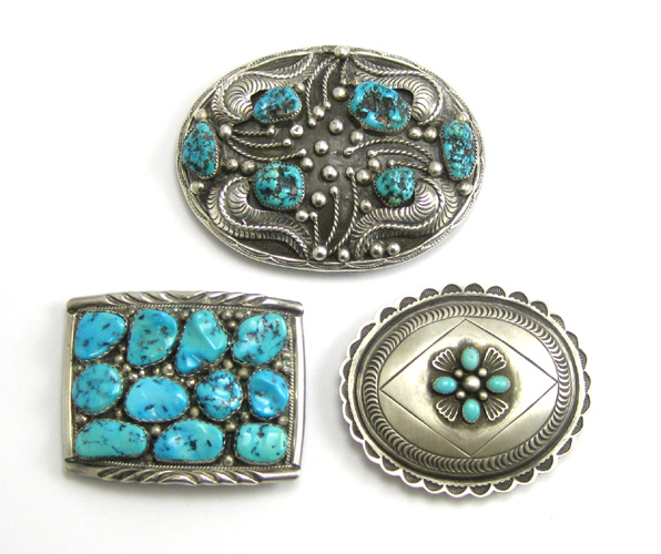 Appraisal: THREE SOUTHWEST NAVAJO STERLING BELT BUCKLES each inset with turquoise