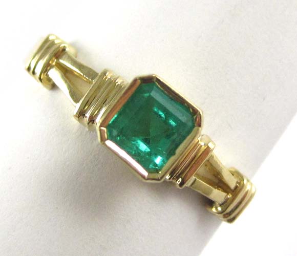 Appraisal: EMERALD AND EIGHTEEN KARAT GOLD SOLITAIRE RING set with an