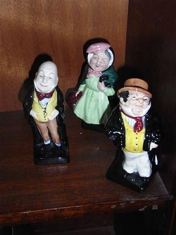 Appraisal: THREE ROYAL DOULTON DICKENS POTTERY FIGURES Micawber Sairey Gamp Captain