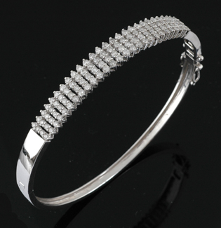 Appraisal: A diamond hinged bangle Comprising one hundred and eight claw