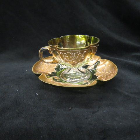 Appraisal: Moser Art Glass Cup Saucer heavy goldwork on emerald green