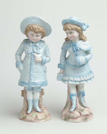 Appraisal: PAIR OF BISQUE DECORATED FIGURINES Both blue outfitted girls One