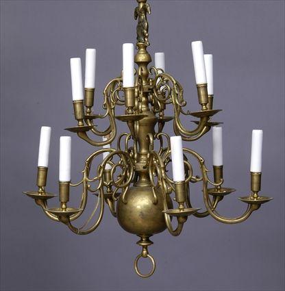 Appraisal: CONTINENTAL BAROQUE-STYLE BRASS TWELVE-LIGHT CHANDELIER The tiered vase stem with