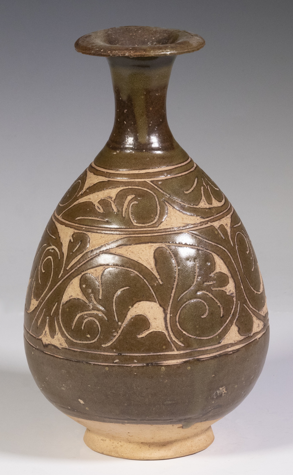 Appraisal: JIN DYNASTY CIZHOU CARVED BOTTLE Floral Relief Carved with brown