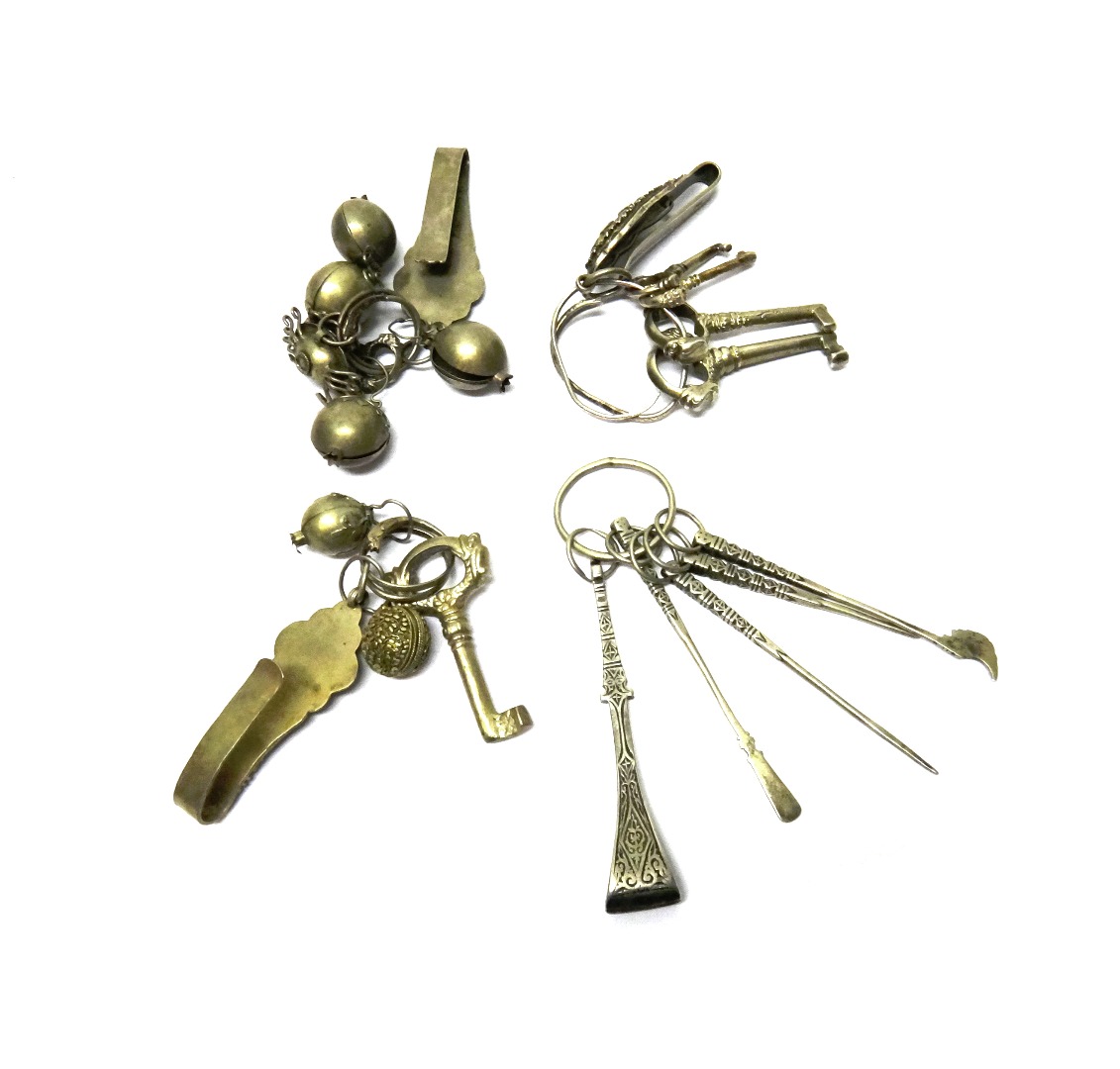 Appraisal: An Oriental keyring fitted with four ornamental keys with a