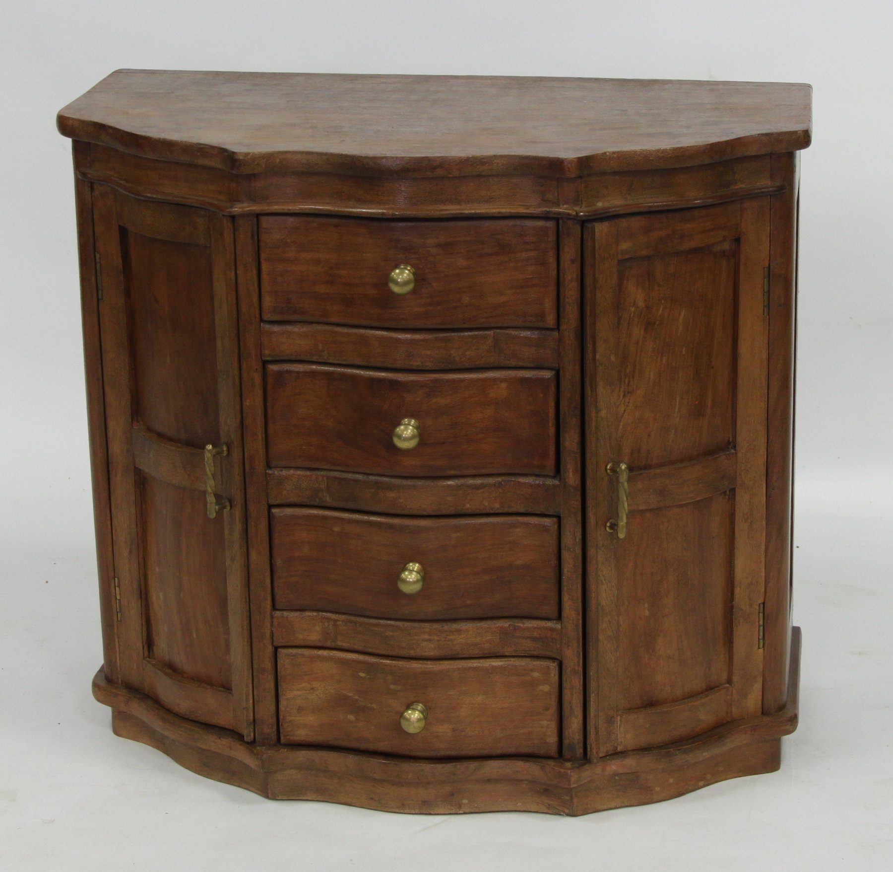 Appraisal: A hardwood side cabinet of serpentine shape fitted four drawers