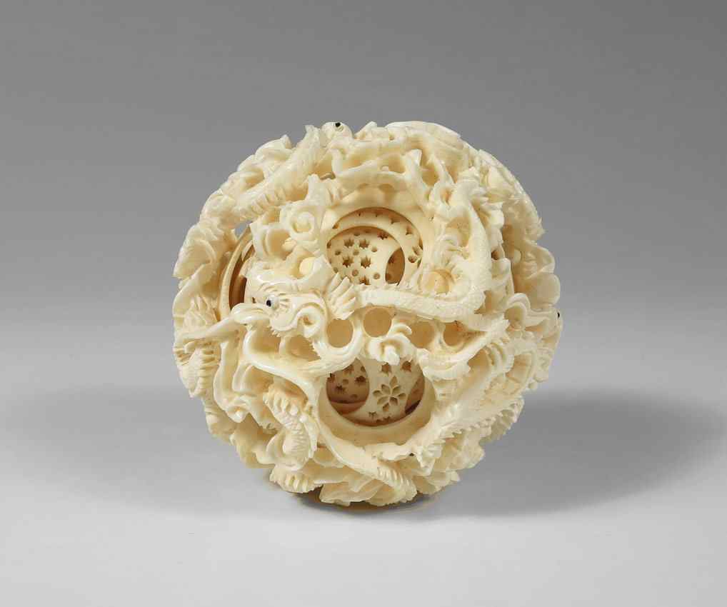 Appraisal: CARVED IVORY MYSTERY BALL Carved dragon exterior at least internal