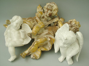 Appraisal: A pair of carved and giltwood cherub musicians height cm