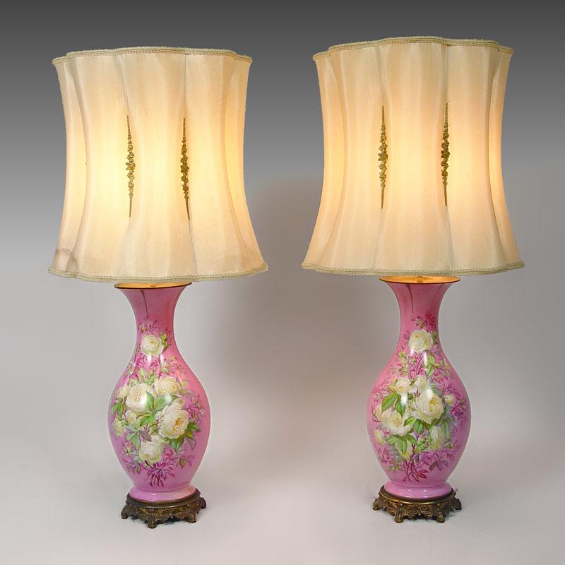 Appraisal: PAIR ROSE PAINTED PORCELAIN LAMPS With original shades and finials