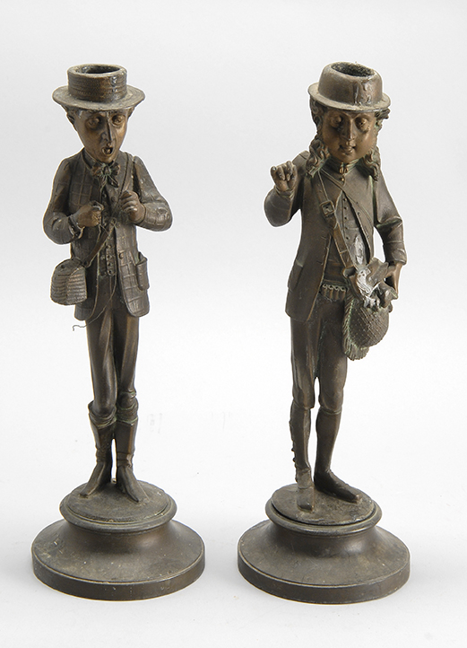 Appraisal: PAIR OF WHITE METAL FIGURAL CANDLESTICKS in Dickensian style depicting