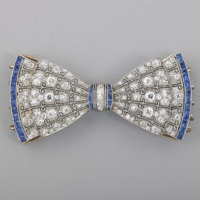 Appraisal: J E CALDWELL DIAMOND AND SAPPHIRE PLATINUM BOW Openwork scroll