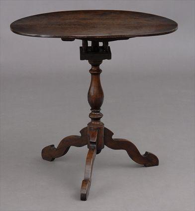 Appraisal: VICTORIAN OAK TILT-TOP TRIPOD TABLE The oval top above birdcage