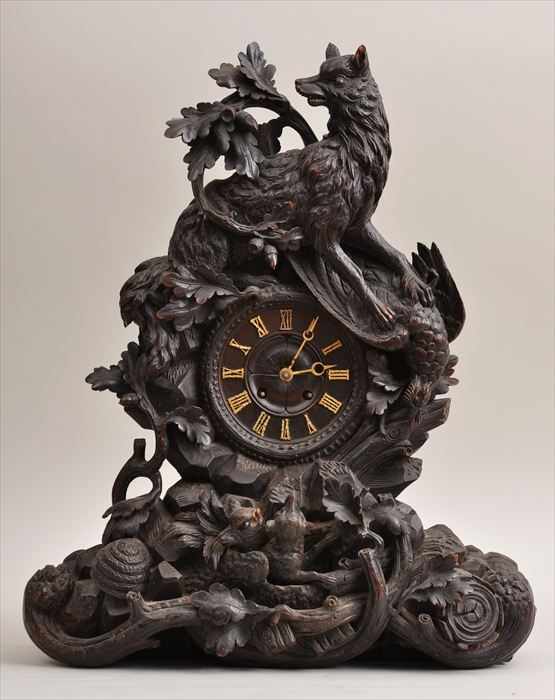 Appraisal: BLACK FOREST CARVED WALNUT MANTEL CLOCK The dial with gilt-metal