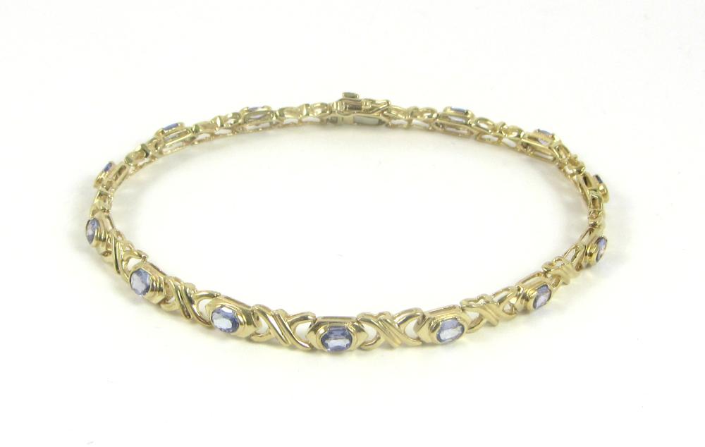 Appraisal: TANZANITE AND YELLOW GOLD BRACELET k yellow gold bezel set