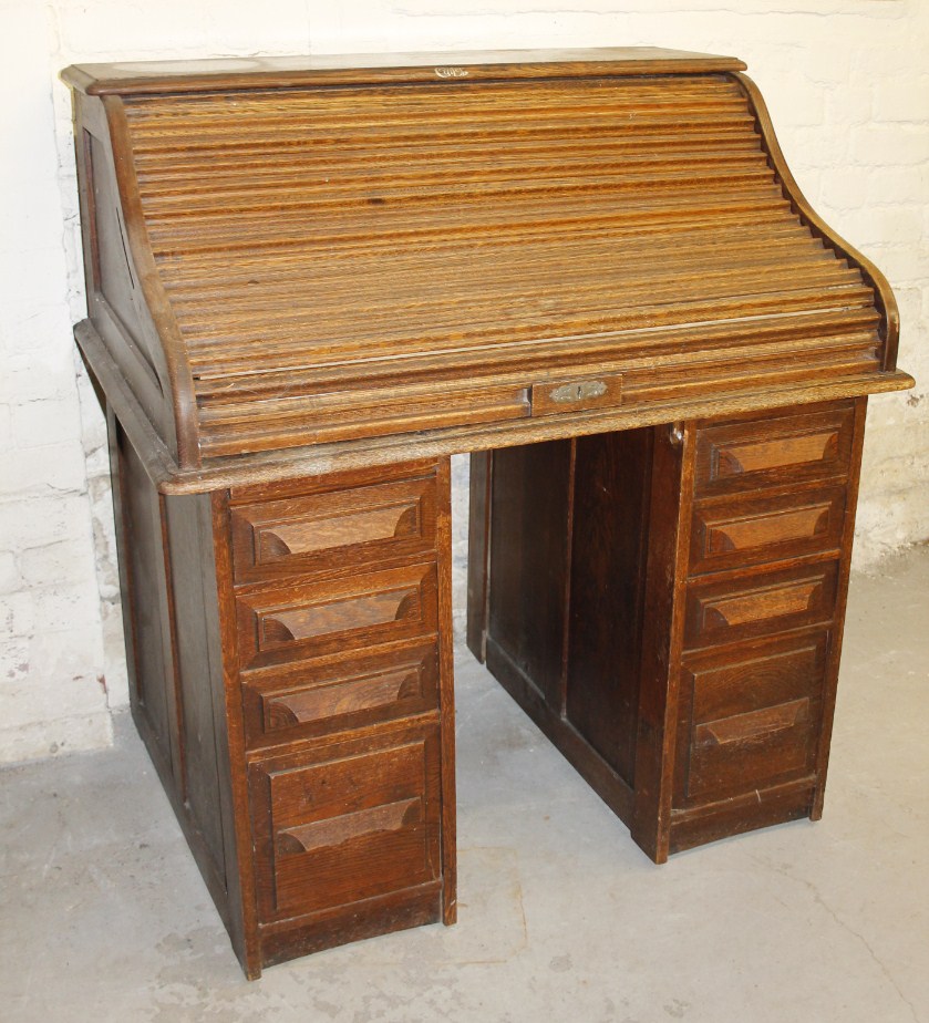 Appraisal: A 's tambour fronted twin pedestal oak desk the upper