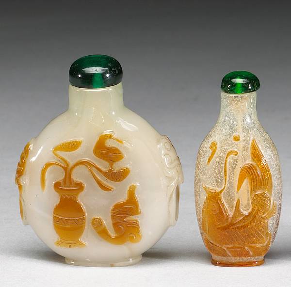 Appraisal: Two amber overlay glass snuff bottles th Century The first