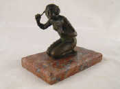 Appraisal: A bronze of a kneeling nude ht cm on a