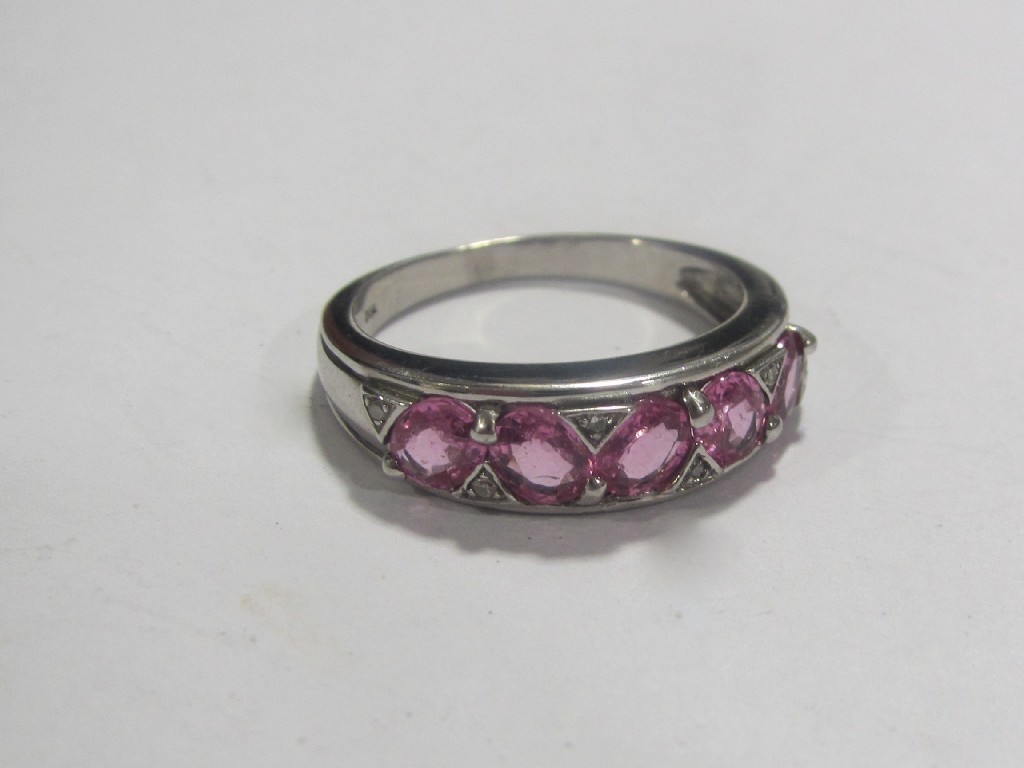 Appraisal: Nine carat white gold pink sapphire and diamond half hoop