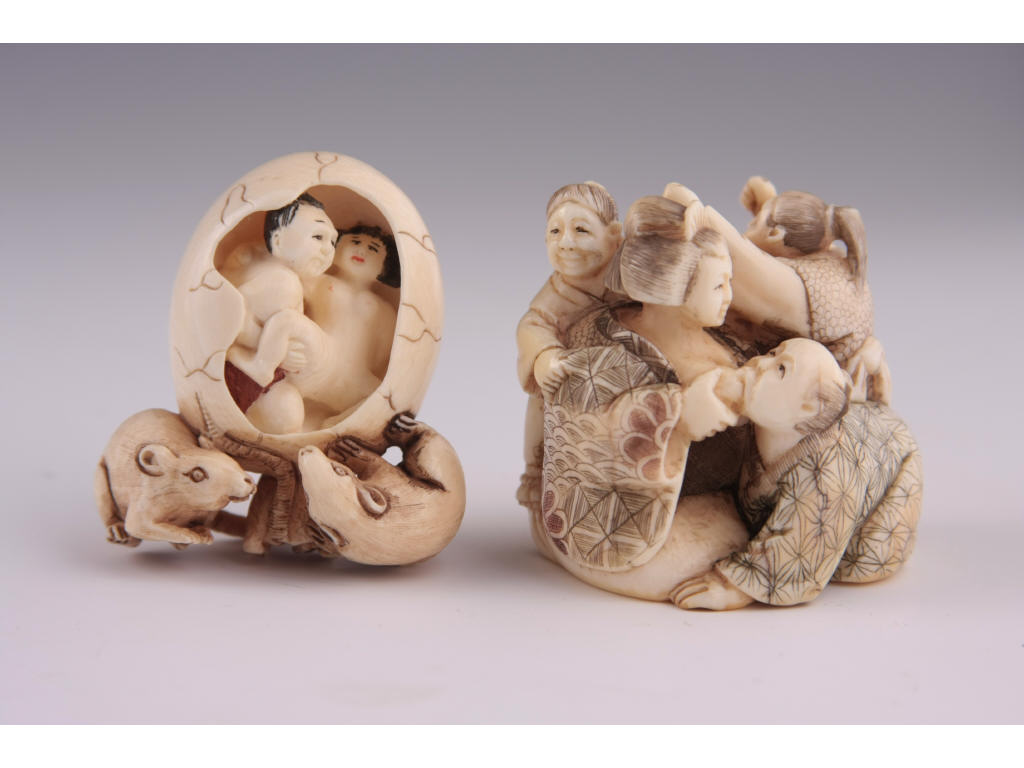 Appraisal: Two Netsuke Erotica Ivory late period carvings a circular one