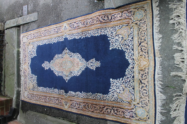 Appraisal: TWO PERSIAN KIRMAN BLUE GROUND RUGS with a central mihrab