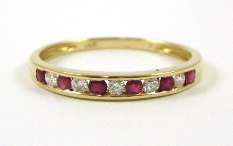 Appraisal: FOURTEEN KARAT GOLD RUBY AND DIAMOND RING the band with