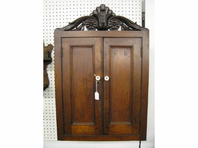 Appraisal: Victorian Carved Walnut Wall Cabinet fancy top locking porcelain pulls